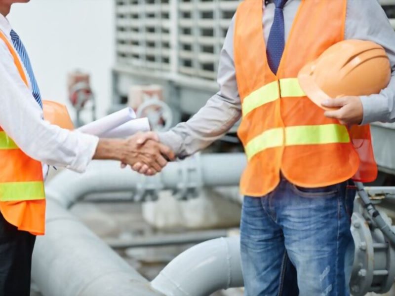 two workers holding each others hand